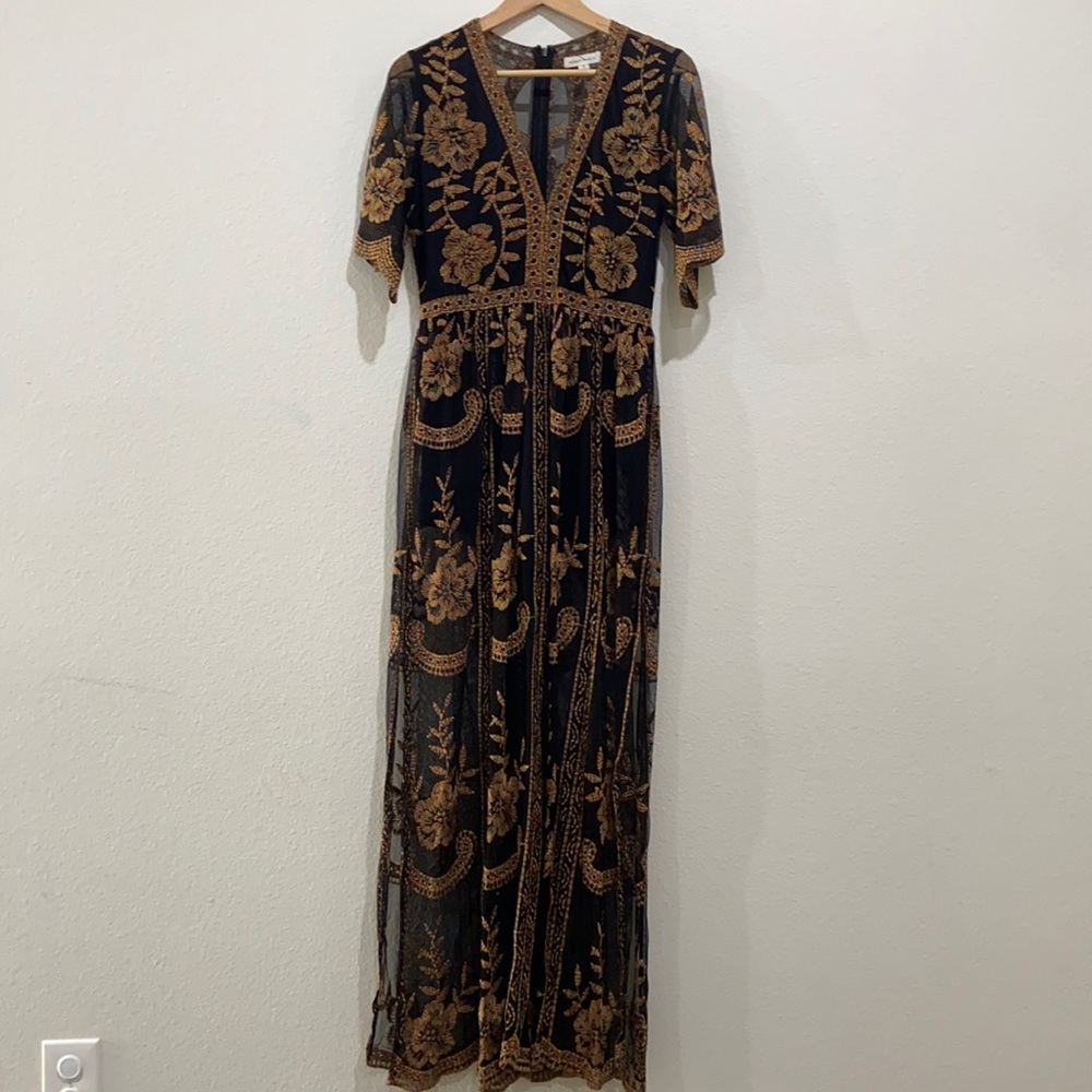 Really pretty black dress with colorful stitching. Size M